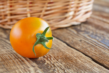 Tomato close-up over the wooden natural background