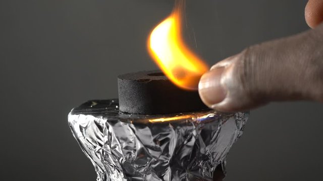 hookah coal lit up with lighter on hookah pot and alll  buring  on it for last