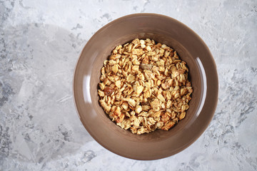 Fitness breakfast. Baked granola in a plate, close-up. Muesli, top view.