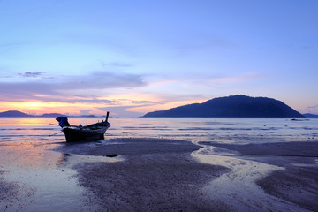 Silhouette fishingboat in sunrise time at La Wai Bay, Phuket province in Thailand.