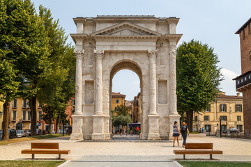 Fototapeta na wymiar VERONA / ITALY - JULY 2015: Ancient Roman Triumphal arch in the historic centre of Verona, Italy