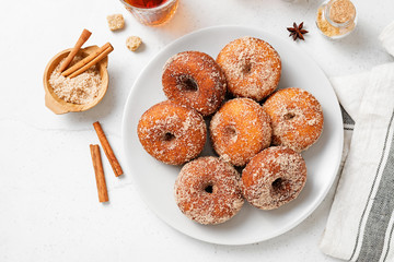 Homemade fresh fried donuts frosted with cinnamon and sugar.