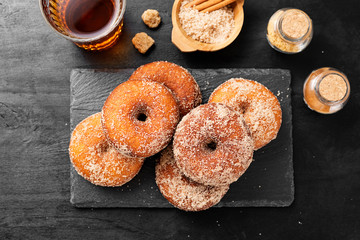 Homemade fresh fried donuts frosted with cinnamon and sugar.