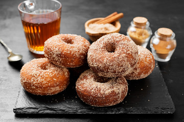 Homemade fresh fried donuts frosted with cinnamon and sugar.