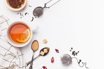 Creative composition witn variety of tea, sugar, lemon and other accessories for making tea