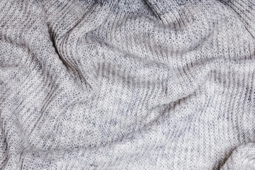 Soft knitted woolen sweater background.