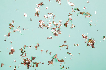 Abstract festive party backdrop with golden confetti on pastel background