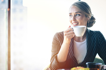 Businesswoman drinking coffee in a cafe.