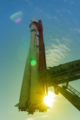 Russian space rocket Vostok at launching platform, lens flare optical effect with color toning
