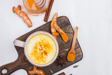 Turmeric drink with honey and spices in a mug,