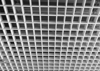 Lattice white suspended ceiling in the office.  View from below.