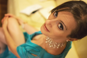 Fototapeta na wymiar Woman in elegant formal dress, sitting with her eyes in the camera