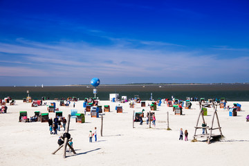 Beach chairs at the public bathing beach of Dornumersiel, East Frisia, Lower Saxony, Germany,...