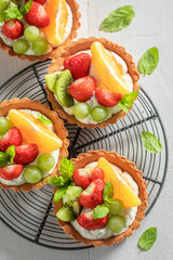 Freshly baked mini tart with fresh fruits and whipped cream