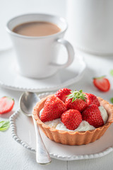 Homemade mini tart with strawberries and cream
