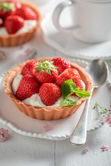 Tasty mini tart with fresh strawberries and mint