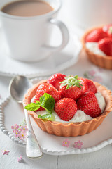 Sweet mini tart with fresh strawberries and mint