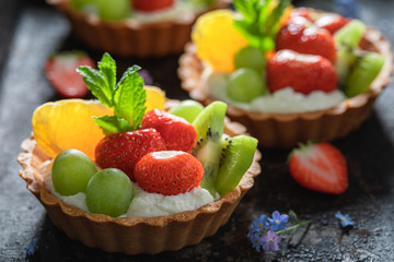 Tasty mini tart made of summer fruits and cream