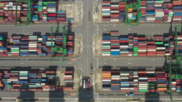 Stunning aerial view of the port of Singapore with trucks and thousands of colored containers ready to be loading on the cargo ships. The Port of Singapore is the second biggest port in the world.