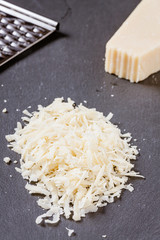 geriebener Parmesankäse auf einer Schiefertafel angerichtet