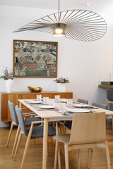 Interior of a dining room with a painting on the wall