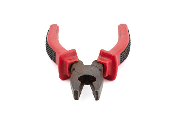 Old red and black pliers isolated on white background.