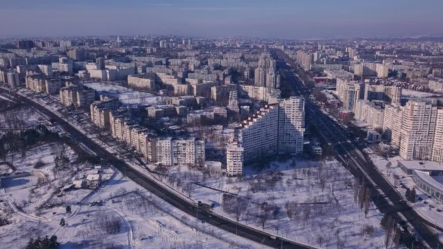 Top view of city in winter at sunset on sky background. Aerial drone videography concept. 4K. Kishinev, Republic of Moldova.