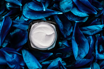 Luxury face cream moisturizer for facial skin on blue flower background, floral essense, spa...