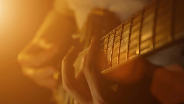 Man performs a guitar melody, close up