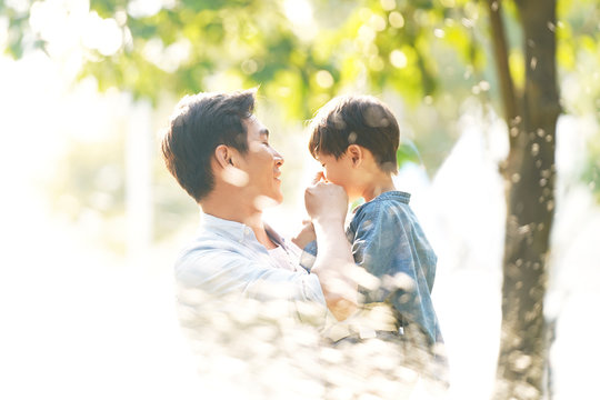 Happy Asian Father And Son Having Fun Outdoors