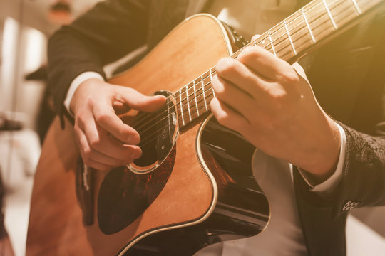 Acoustic guitar playing. A man playing an acoustic guitar.