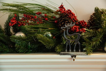 Christmas fireplace hanger reindeer with green garland cherry and bauballs