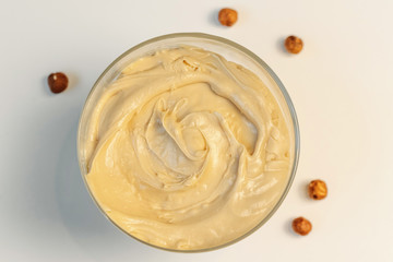 Walnut cream. Sweet cream in glass bowl. Confectionery, sweet life, calories.