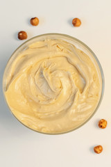 Walnut cream. Sweet cream in glass bowl. Confectionery, sweet life, calories.