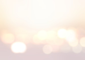 Bright lights on pastel beige empty background. Gleaming festive blurred texture. Wonderful delicate template. © avextra