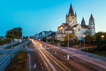 Fototapeta premium St. Francis of Assisi Church in Vienna evening view with traffic light trails