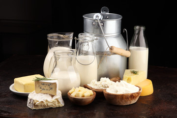 Different  healthy dairy products on rustic background with milk, cheese, butter and cottage