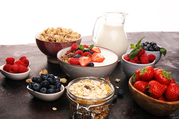 Tasty homemade granola served on table. Healthy breakfast with a bowl of oatmeal with banana, blueberries, strawberries and healthy food for Breakfast