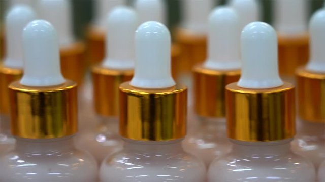 Row of cosmetic bottles with a cream.