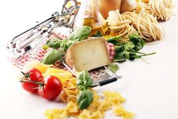 Pasta, vegetables, herbs and spices for Italian food on rustic table