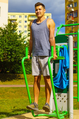 Man doing sit ups in outdoor gym