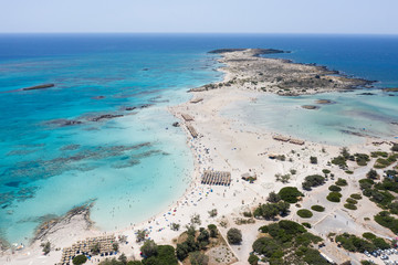 Fototapeta na wymiar Aerial drone shot of beautiful turquoise beach with pink sand Elafonisi Crete Greece. Best beaches of Mediterranean
