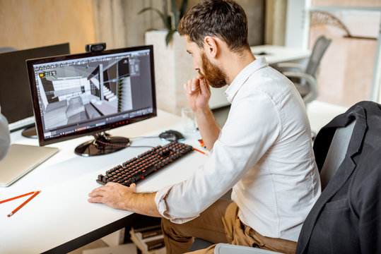 Thoughtful office employee working as an interior designer, 3d modeling on the computer in the office