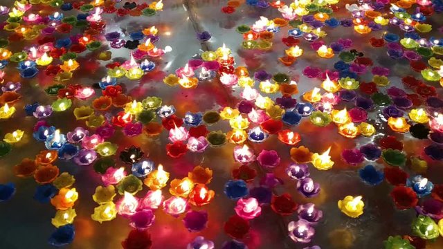 Krathongs made from candles that float on the water. Is a merit-making based on the beliefs of Thai Buddhists