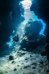 woman diver visiting underwater cave in the Red Sea, egypt, Shaab Claude