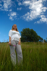 Beautiful pregnant woman relaxing outside in the park