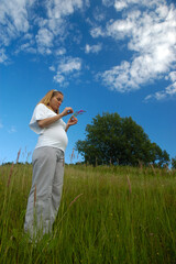Beautiful pregnant woman relaxing outside in the park
