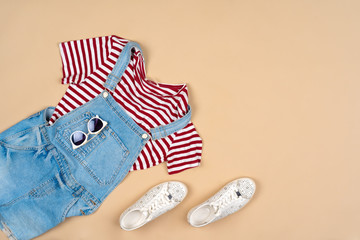 Fashion outfit for a woman on a beige background top view