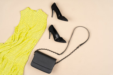 Fashion outfit for a woman on a beige background top view