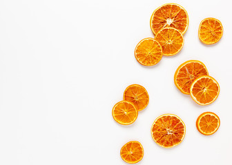  Christmas composition with dried oranges slices on white background. Natural dry food ingredient...